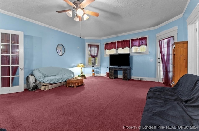 living room with ornamental molding, ceiling fan, carpet flooring, and a textured ceiling