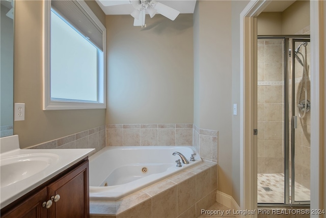 bathroom with vanity, ceiling fan, and shower with separate bathtub