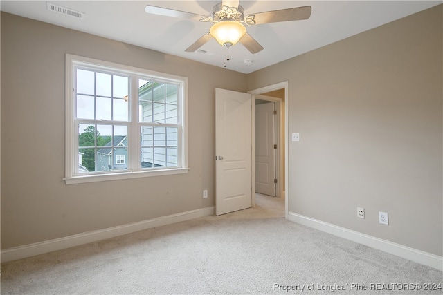 unfurnished room featuring light carpet and ceiling fan