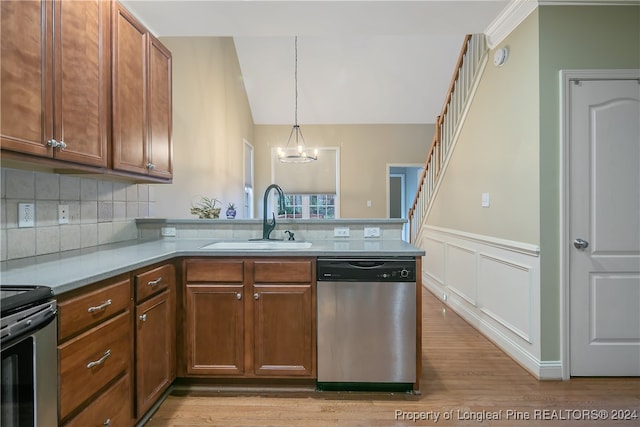 kitchen with light hardwood / wood-style floors, sink, appliances with stainless steel finishes, and tasteful backsplash