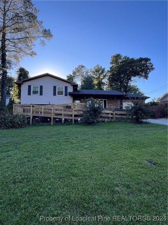 rear view of house featuring a yard