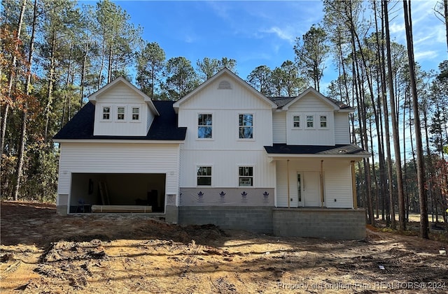 view of front facade with a porch and a garage