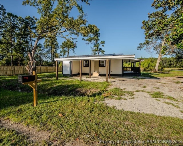 back of house featuring a carport