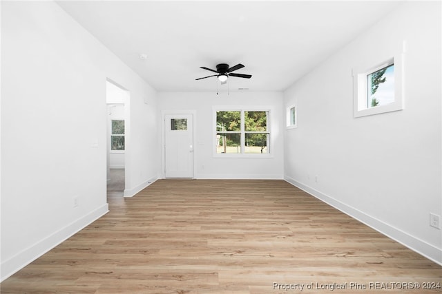 empty room with ceiling fan and light wood-type flooring