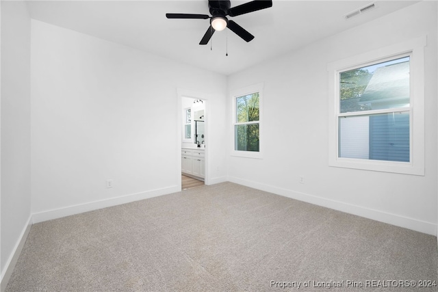 carpeted empty room featuring ceiling fan