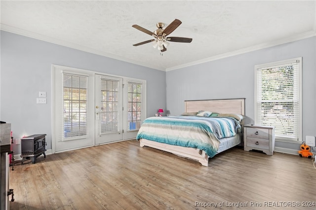 bedroom with multiple windows, crown molding, hardwood / wood-style floors, and ceiling fan