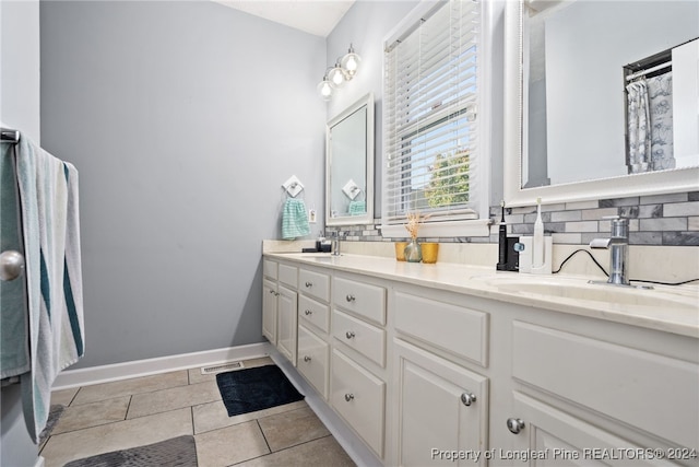 bathroom featuring decorative backsplash, tile patterned flooring, and vanity