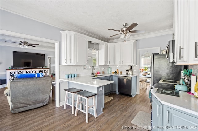 kitchen with sink, white cabinets, a healthy amount of sunlight, and appliances with stainless steel finishes