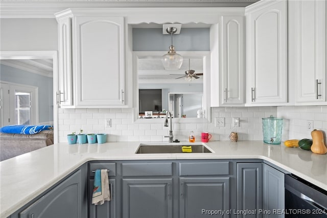 kitchen featuring ceiling fan, white cabinetry, sink, and tasteful backsplash