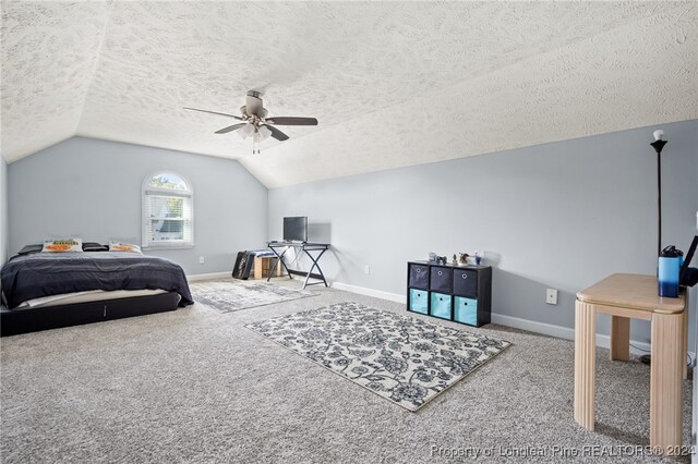 bedroom featuring a textured ceiling, ceiling fan, carpet floors, and vaulted ceiling