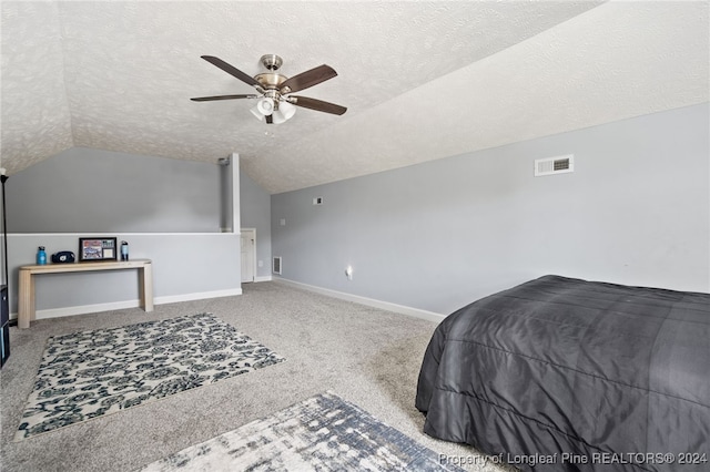 carpeted bedroom with a textured ceiling, vaulted ceiling, and ceiling fan