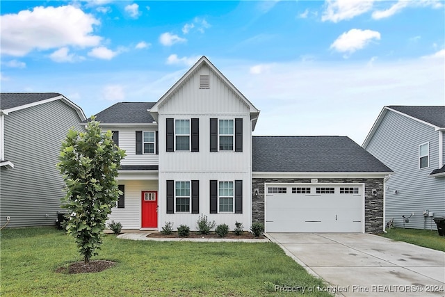 view of front of house with a front yard and a garage