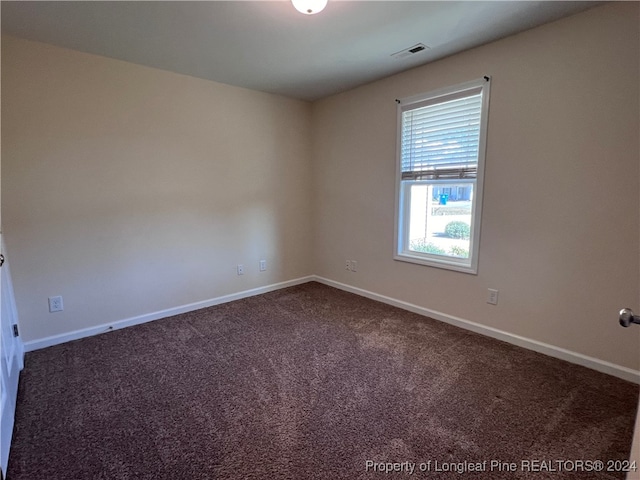 empty room with dark carpet