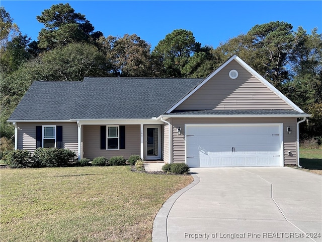 single story home featuring a front yard and a garage