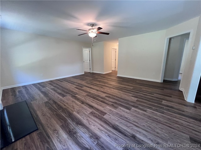 spare room featuring dark wood-type flooring and ceiling fan