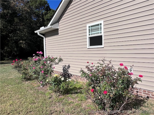 view of side of home with a lawn