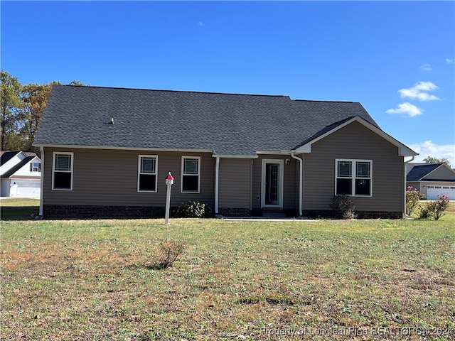 view of front of home featuring a garage and a front lawn