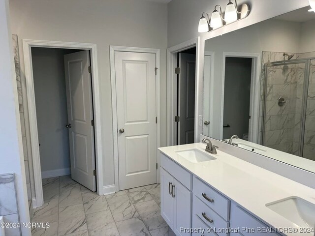 bathroom with vanity, a shower with shower door, and toilet