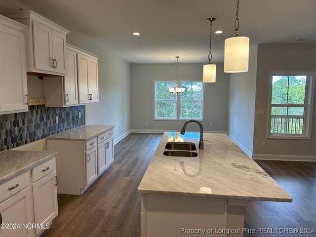 kitchen with a center island with sink, sink, white cabinets, and dark hardwood / wood-style floors