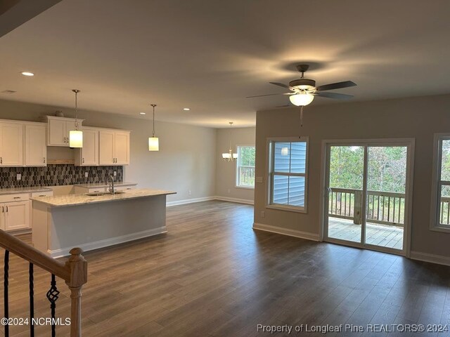 kitchen featuring white cabinetry, decorative backsplash, a wealth of natural light, and dark hardwood / wood-style floors