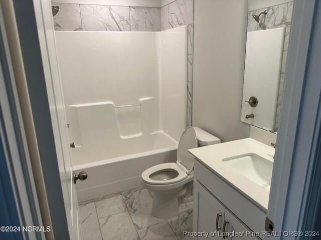 full bathroom featuring toilet, tiled shower / bath, and vanity