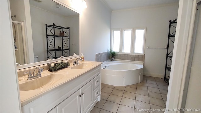 bathroom with ornamental molding, tile patterned flooring, a washtub, and vanity