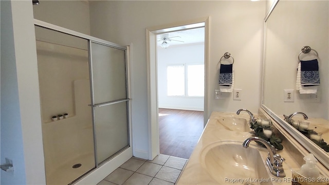 bathroom featuring vanity, hardwood / wood-style flooring, ceiling fan, and a shower with shower door