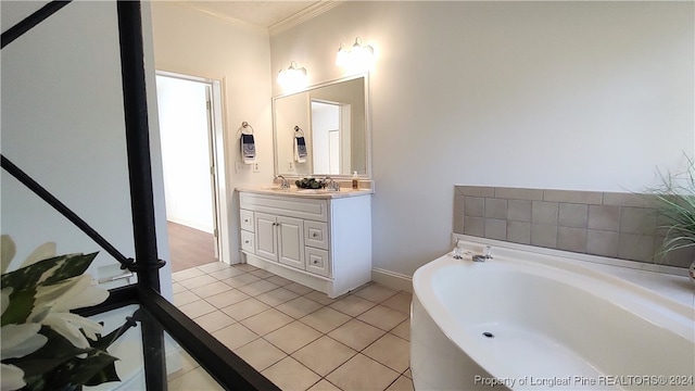 bathroom with crown molding, a washtub, vanity, and tile patterned floors