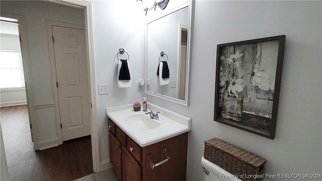 bathroom featuring hardwood / wood-style flooring, vanity, and toilet