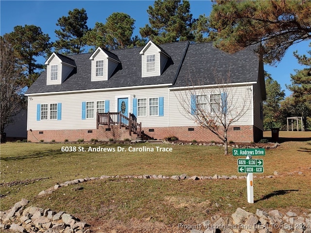 cape cod-style house featuring a front lawn