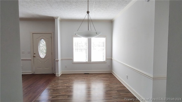 entryway featuring dark hardwood / wood-style flooring, a textured ceiling, and ornamental molding