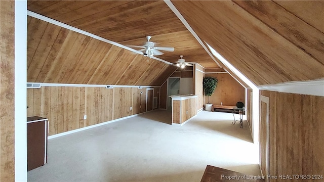 bonus room featuring wooden ceiling, light carpet, ceiling fan, wooden walls, and vaulted ceiling