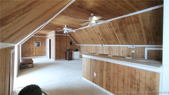 additional living space featuring wood walls, lofted ceiling, wooden ceiling, and ceiling fan