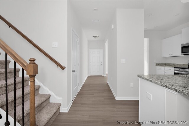 corridor with hardwood / wood-style floors