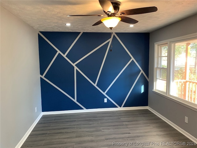 spare room with a textured ceiling, hardwood / wood-style flooring, and ceiling fan