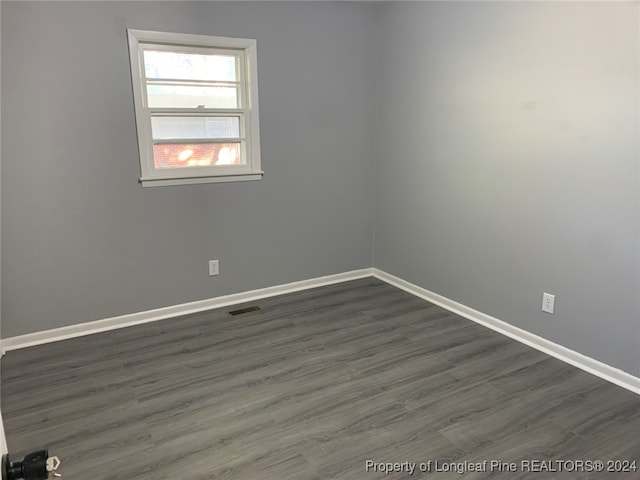 spare room featuring dark hardwood / wood-style flooring