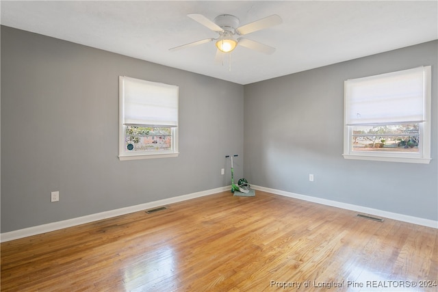 spare room featuring ceiling fan, plenty of natural light, and light hardwood / wood-style flooring