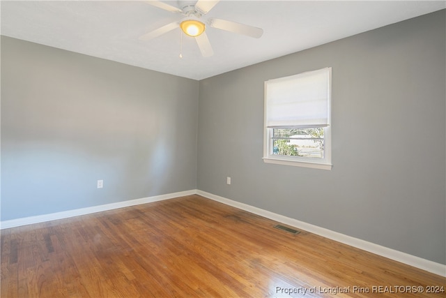 empty room with wood-type flooring and ceiling fan