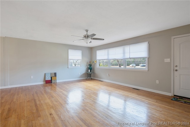 empty room with light wood-type flooring and ceiling fan