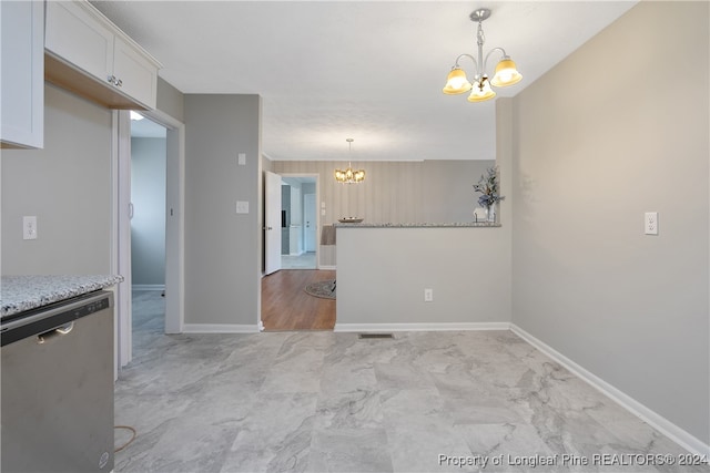 kitchen with white cabinetry, stainless steel dishwasher, decorative light fixtures, and a notable chandelier