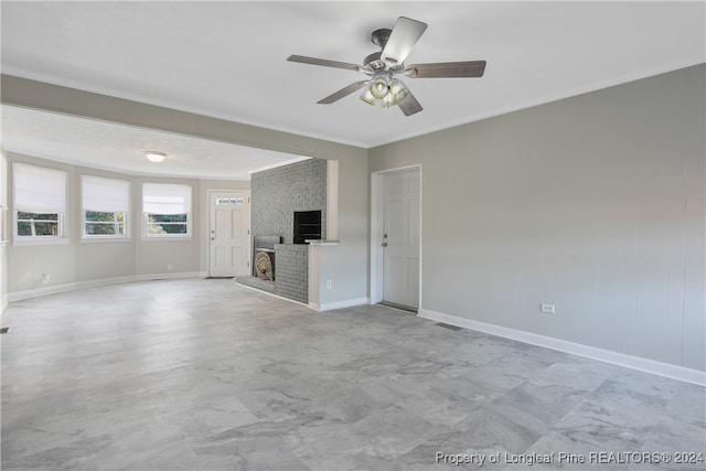 unfurnished living room featuring a fireplace, ceiling fan, and crown molding