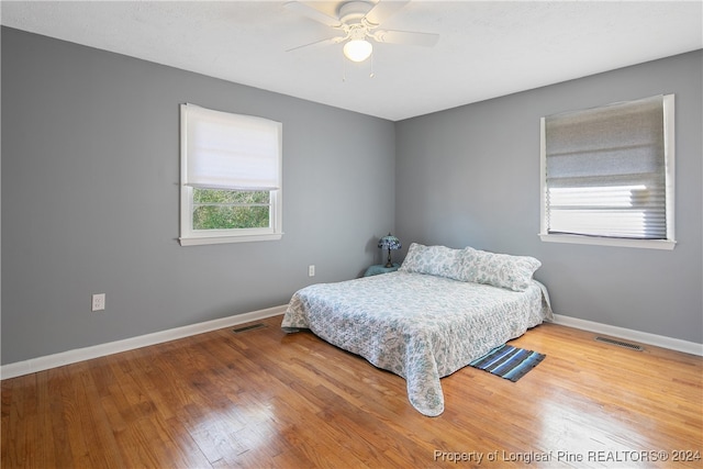 bedroom with wood-type flooring and ceiling fan