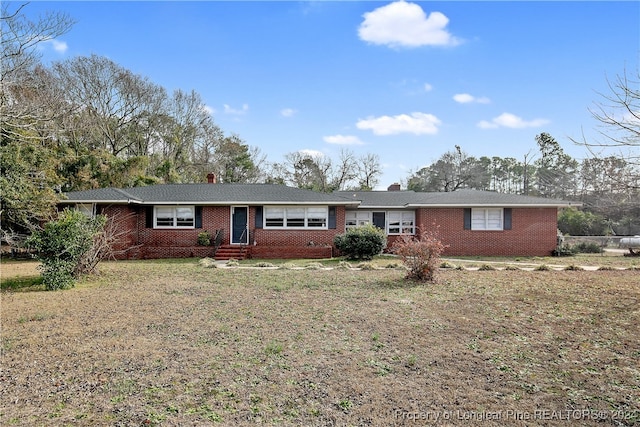 ranch-style home featuring a front yard