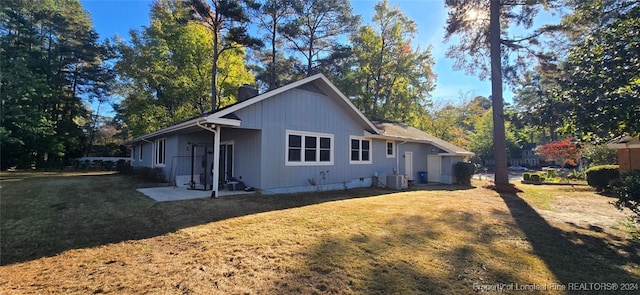 view of property exterior featuring a lawn and central AC unit