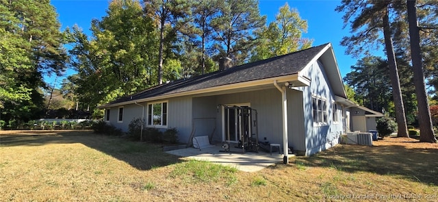 view of side of property with a lawn and a patio