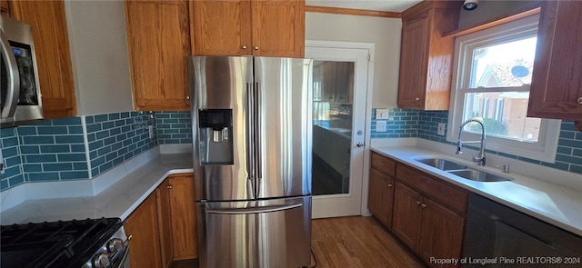 kitchen featuring tasteful backsplash, a wealth of natural light, sink, and appliances with stainless steel finishes