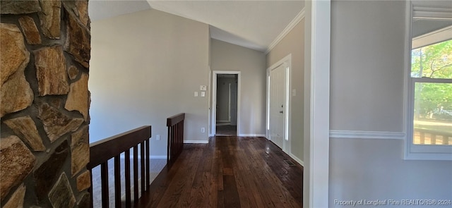 hall with wood-type flooring, ornamental molding, and lofted ceiling