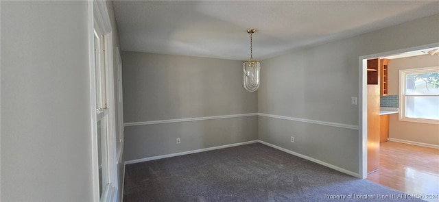 empty room featuring dark colored carpet