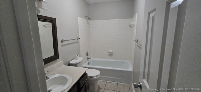 full bathroom featuring tile patterned flooring, vanity, toilet, and tiled shower / bath