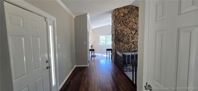 foyer entrance with lofted ceiling, dark wood-type flooring, and ornamental molding